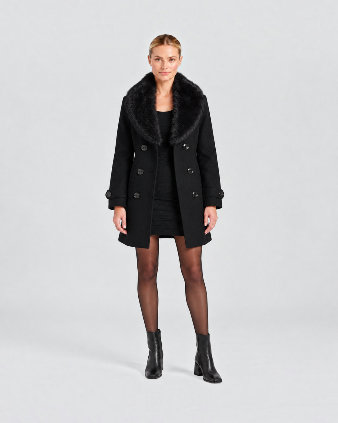 Luna Moda black short tailored coat with faux fur collar worn by a model over a black dress and boots