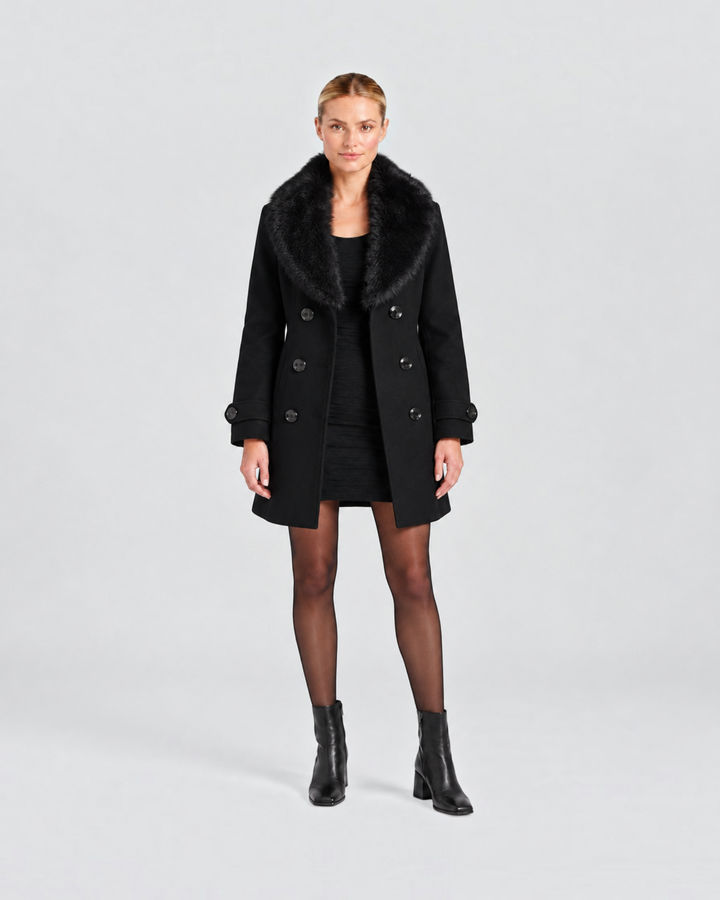 Luna Moda black short tailored coat with faux fur collar worn by a model over a black dress and boots