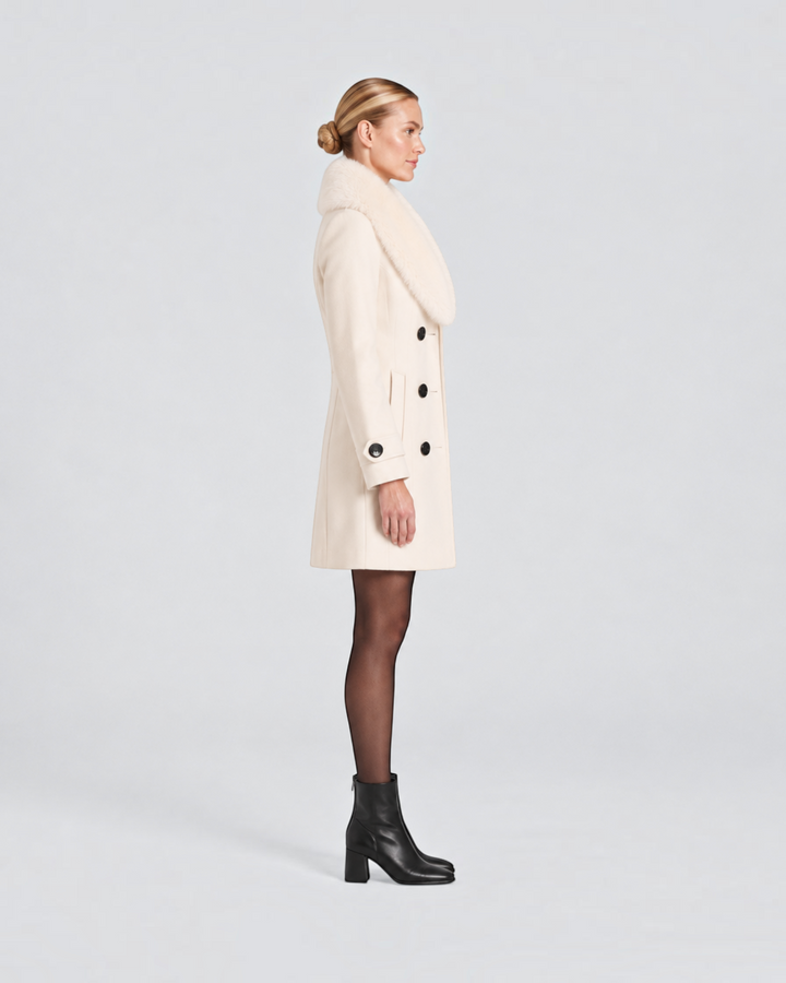 Luna Moda cream short tailored winter coat with a faux fur collar worn by a model in profile view