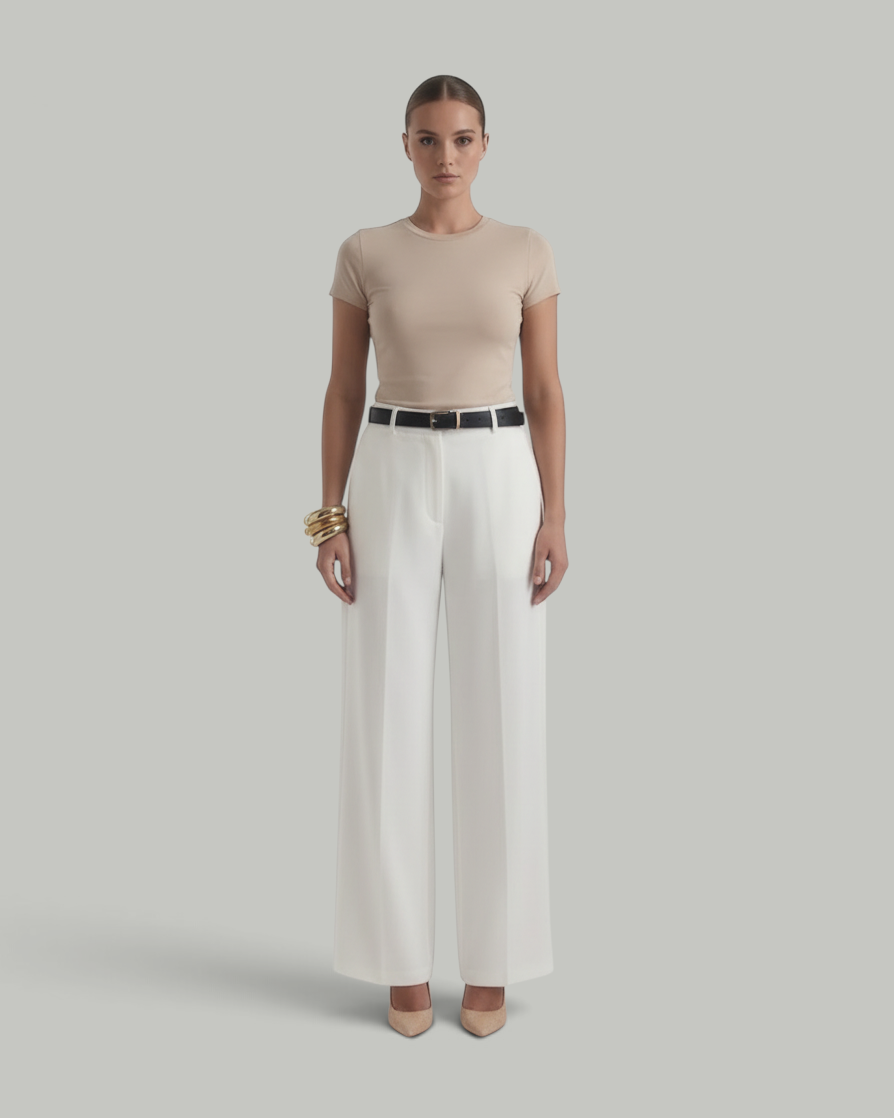 Model wearing Luna Moda white high-waisted wide-leg trousers with front pleats and a black belt