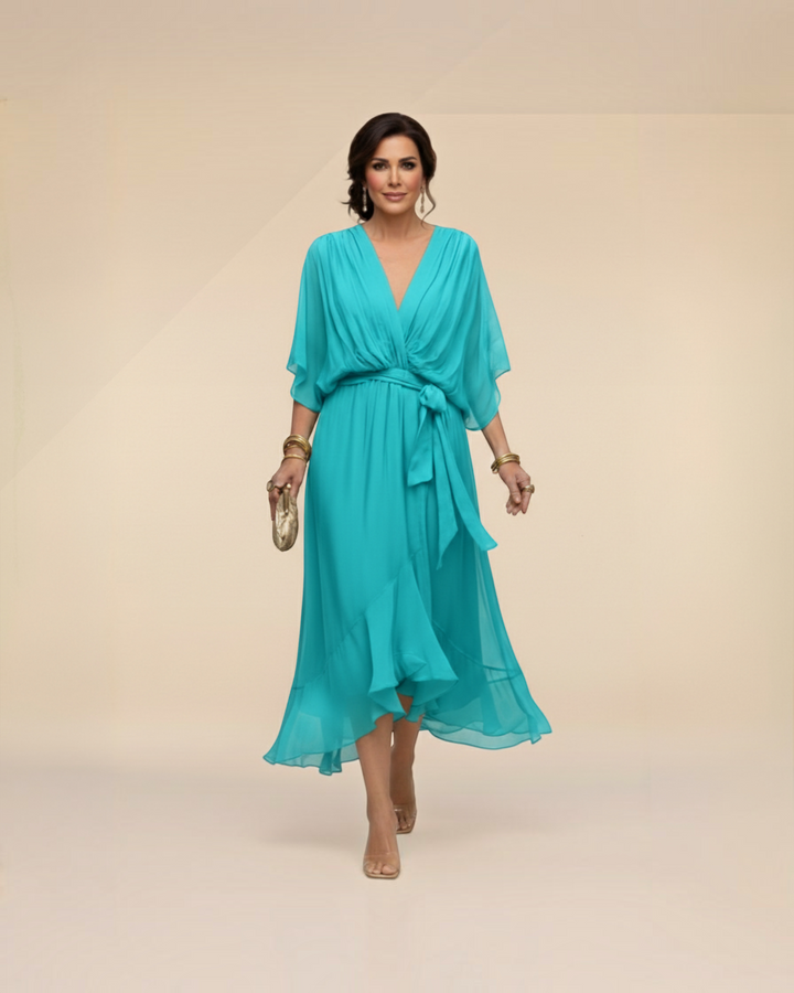 Luna Moda Monica turquoise chiffon midi dress with V-neck, flutter sleeves, and tie waist on a model
