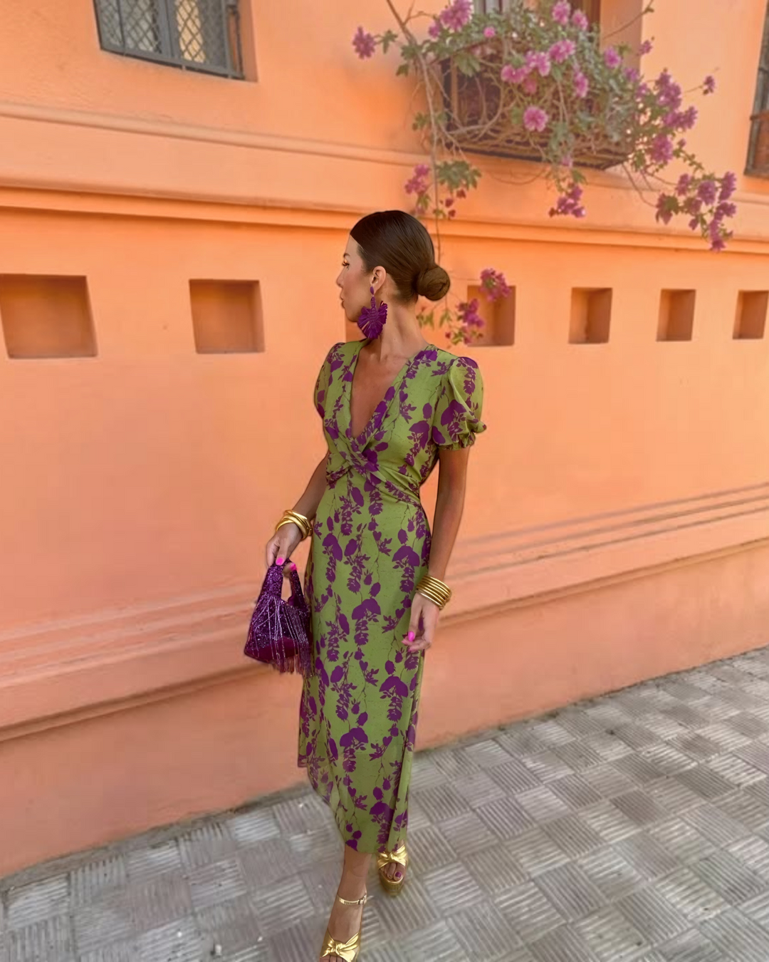 Luna Moda Andrea floral midi dress in green and purple with puff sleeves and V-neck, worn by a woman outdoors.