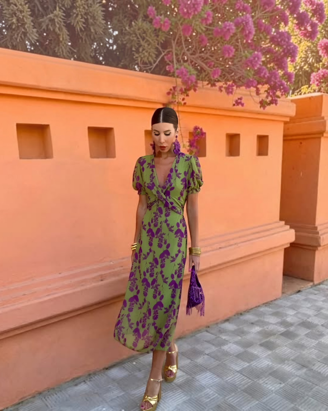 Luna Moda Andrea midi dress in green and purple floral print with V-neck and puff sleeves, worn by a model outdoors.