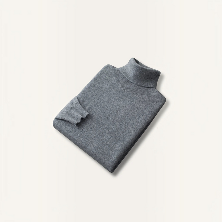 Luna Moda grey 100% cashmere turtleneck sweater with ribbed collar and cuffs, folded flat on a neutral background.