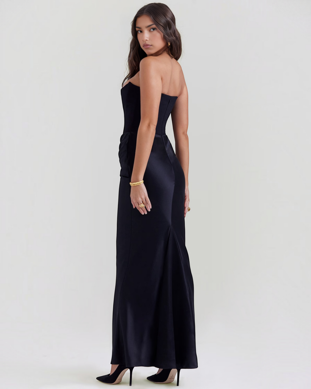 Luna Moda Leilani black strapless evening gown with side draping and a sleek, floor-length silhouette on a model.