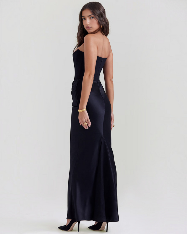 Luna Moda Leilani black strapless evening gown with side draping and a sleek, floor-length silhouette on a model.