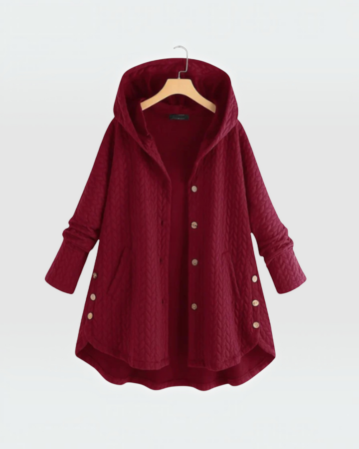 Luna Moda burgundy quilted hooded jacket with decorative side buttons and a loose fit on a hanger