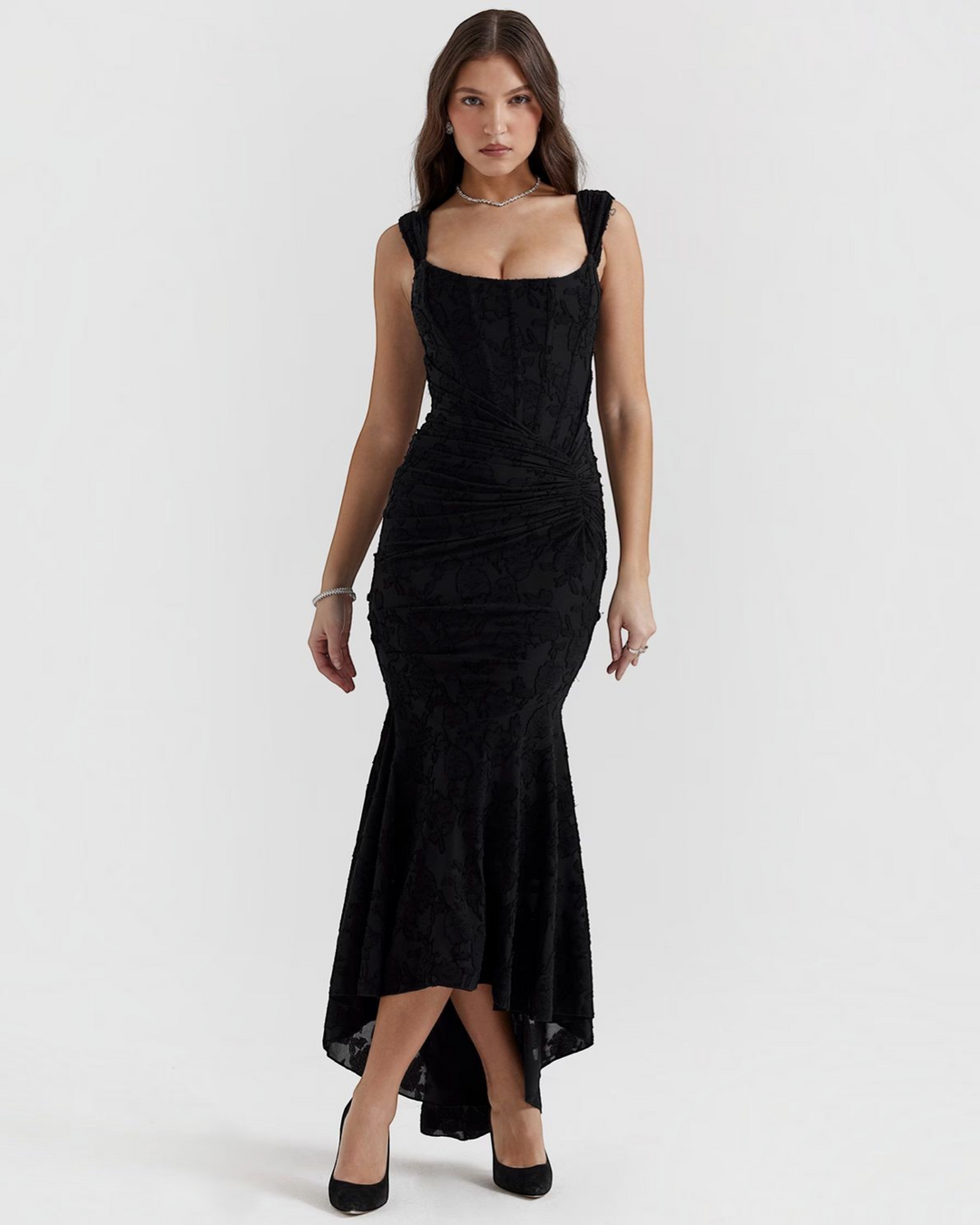 Model wearing a black Luna Moda Katerina midi dress with a floral pattern, corset bodice, and ruched waist detail.