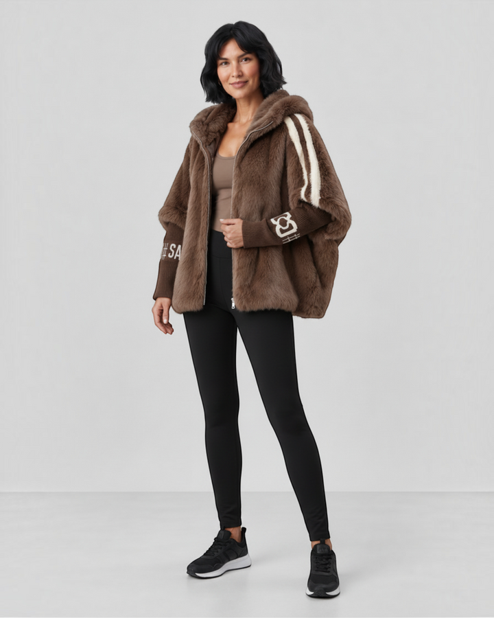 Luna Moda brown faux fur hooded jacket with contrast striped sleeves and ribbed cuffs worn by a woman