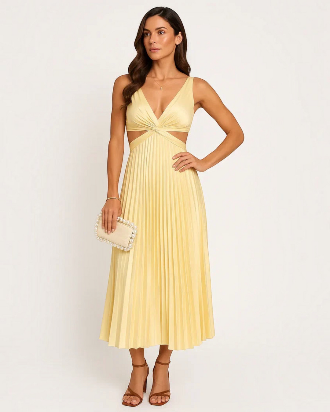 Luna Moda yellow pleated maxi dress with a V-neck, cut-out waist, and flowing skirt worn by a model with a clutch.