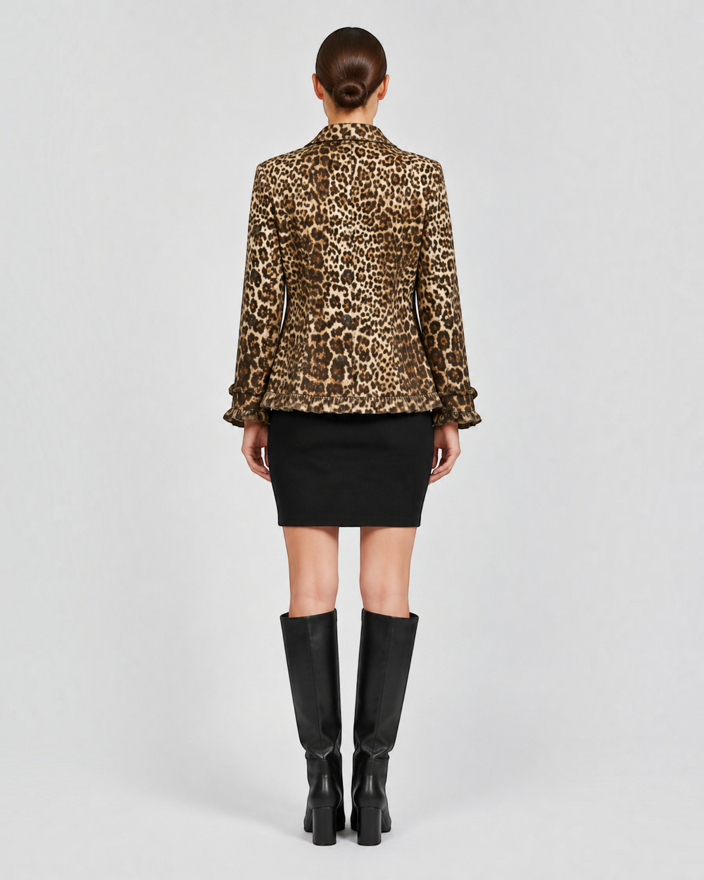 Luna Moda Giuliana leopard print jacket with ruffled hem and cuffs, back view on a model wearing a black skirt.