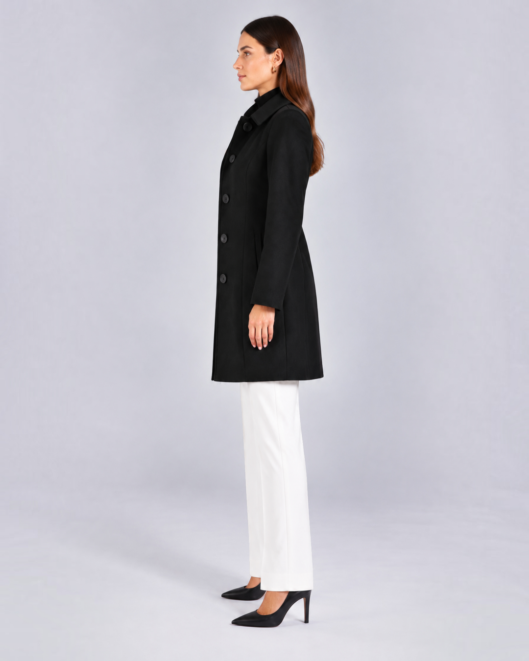 Luna Moda black fit and flare coat with buttons and classic collar worn by a model in profile view