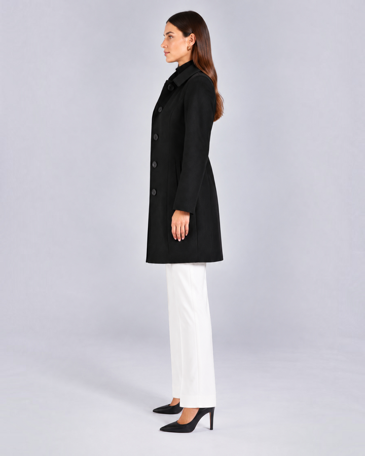Luna Moda black fit and flare coat with buttons and classic collar worn by a model in profile view