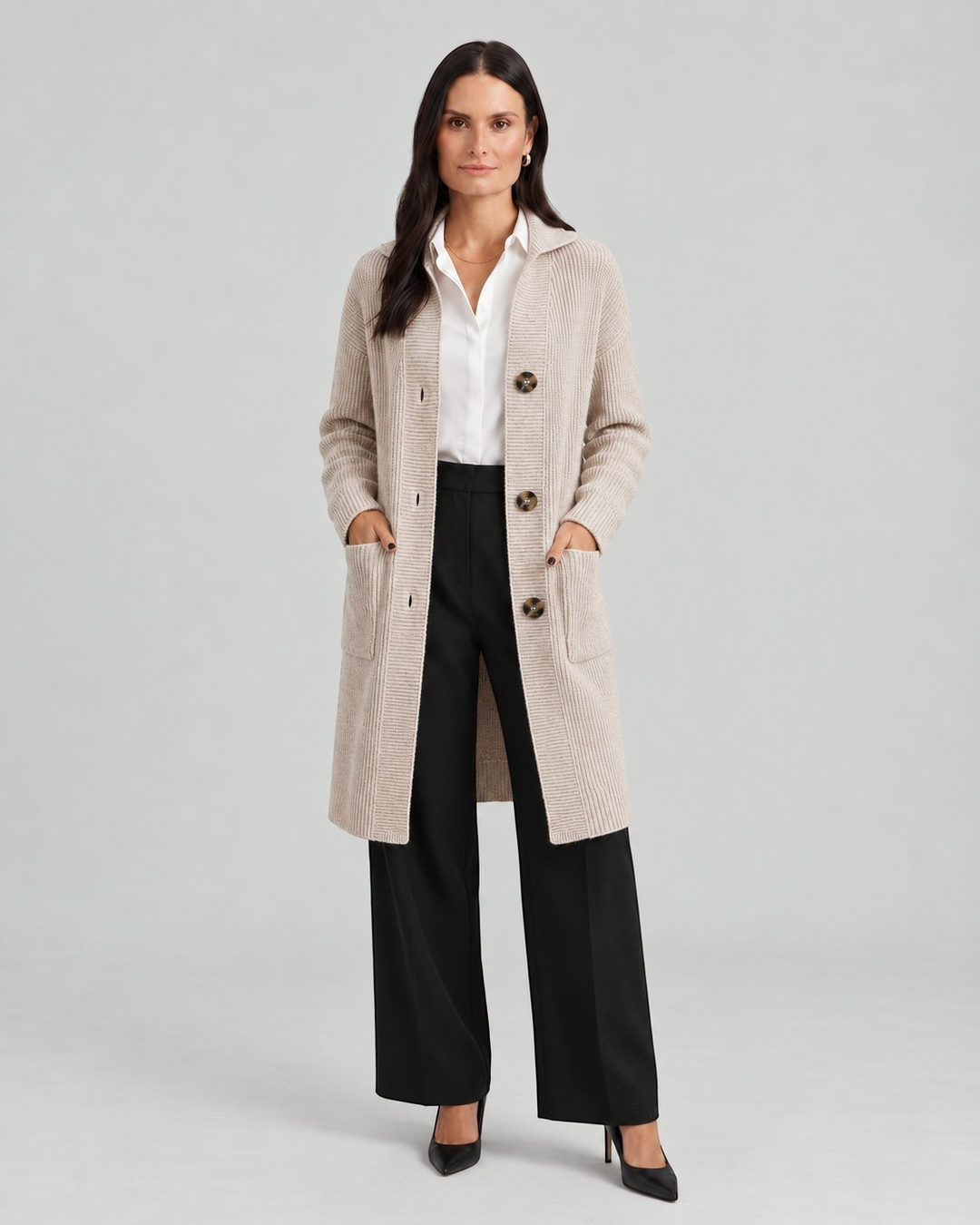 Luna Moda Chiara long beige ribbed knit cardigan with button closure and front pockets worn by a model