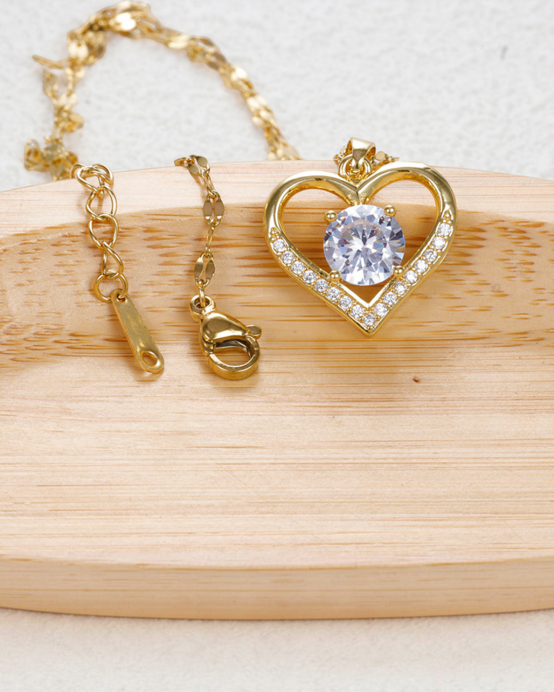Luna Moda gold heart necklace featuring a central cubic zirconia stone and side diamonds on a delicate chain