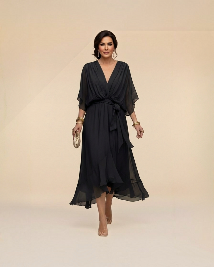 Luna Moda Monica black chiffon midi dress with V-neck, flowing sleeves, and waist tie worn by a woman