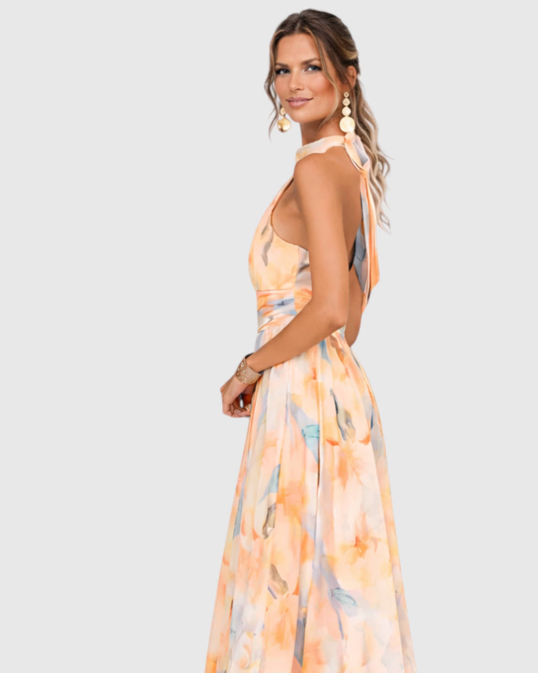 Luna Moda Aurora maxi dress with halter neck and artistic watercolor floral print, worn by a model in profile view.