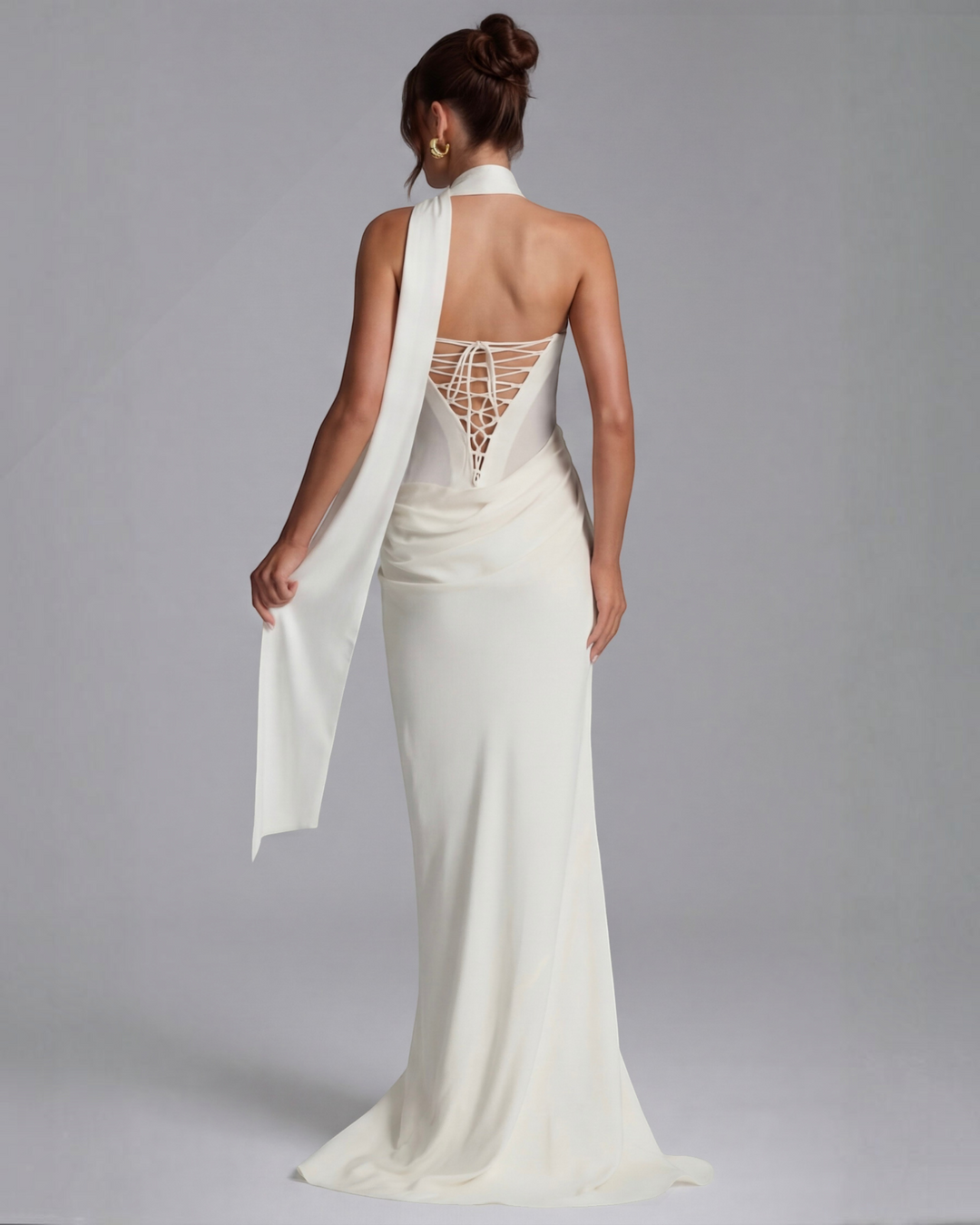 Luna Moda white maxi dress with corset-style lace-up back, draped fabric, and elegant floor-length silhouette.