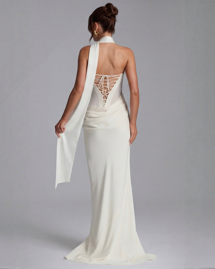 Luna Moda white maxi dress with corset-style lace-up back, draped fabric, and elegant floor-length silhouette.