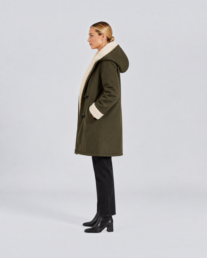 Luna Moda Antonia olive green hooded winter coat with cream faux shearling lining worn by a model in profile view