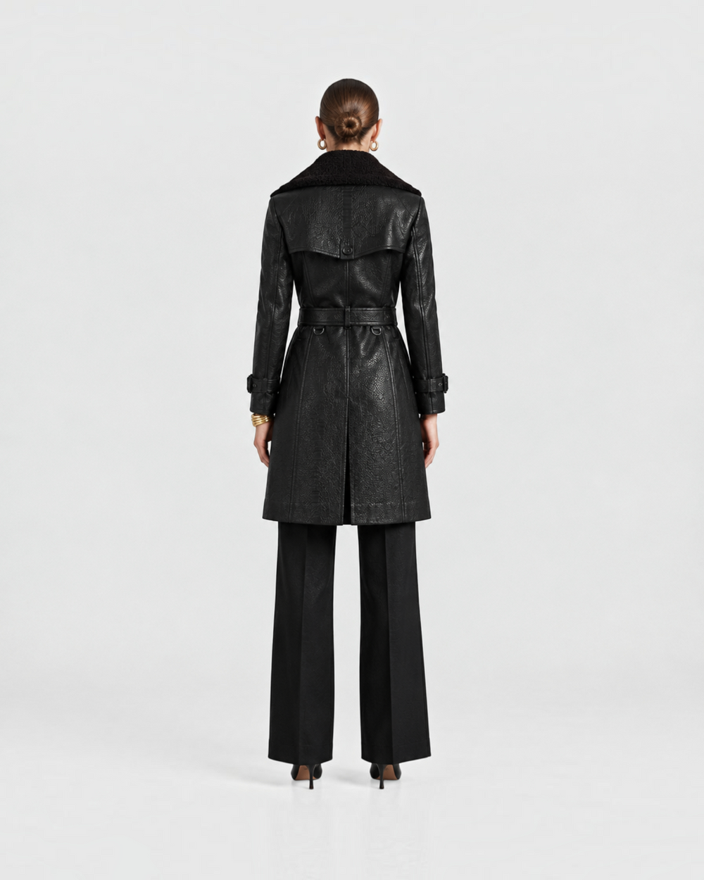 Luna Moda LAURA black trench coat with wide collar, belted waist, and sleeve buckles, back view on a model.