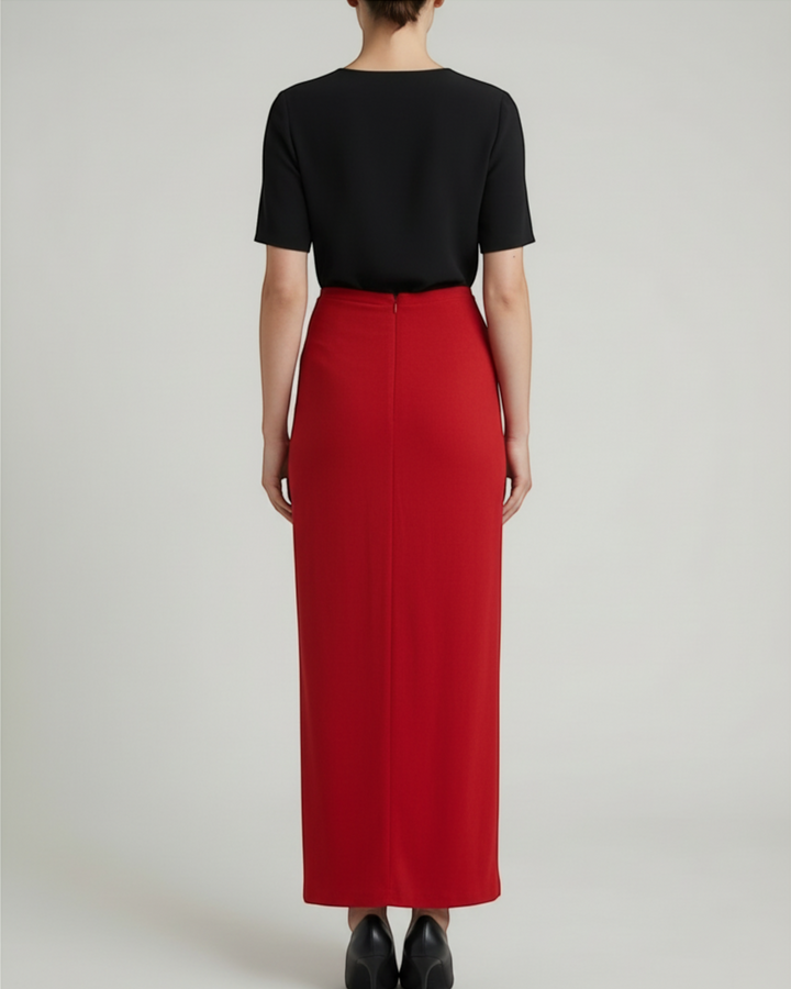 Luna Moda red midi skirt worn with a black top and heels, viewed from the back, featuring a sleek silhouette.