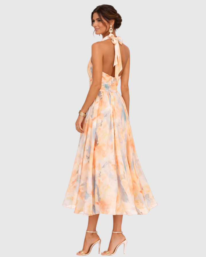 Luna Moda Aurora maxi dress with halter neck and artistic watercolor floral print on a model, back view