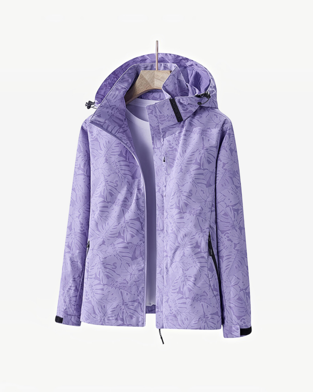 Luna Moda lightweight purple waterproof rain jacket with a tropical leaf print and adjustable hood on a hanger