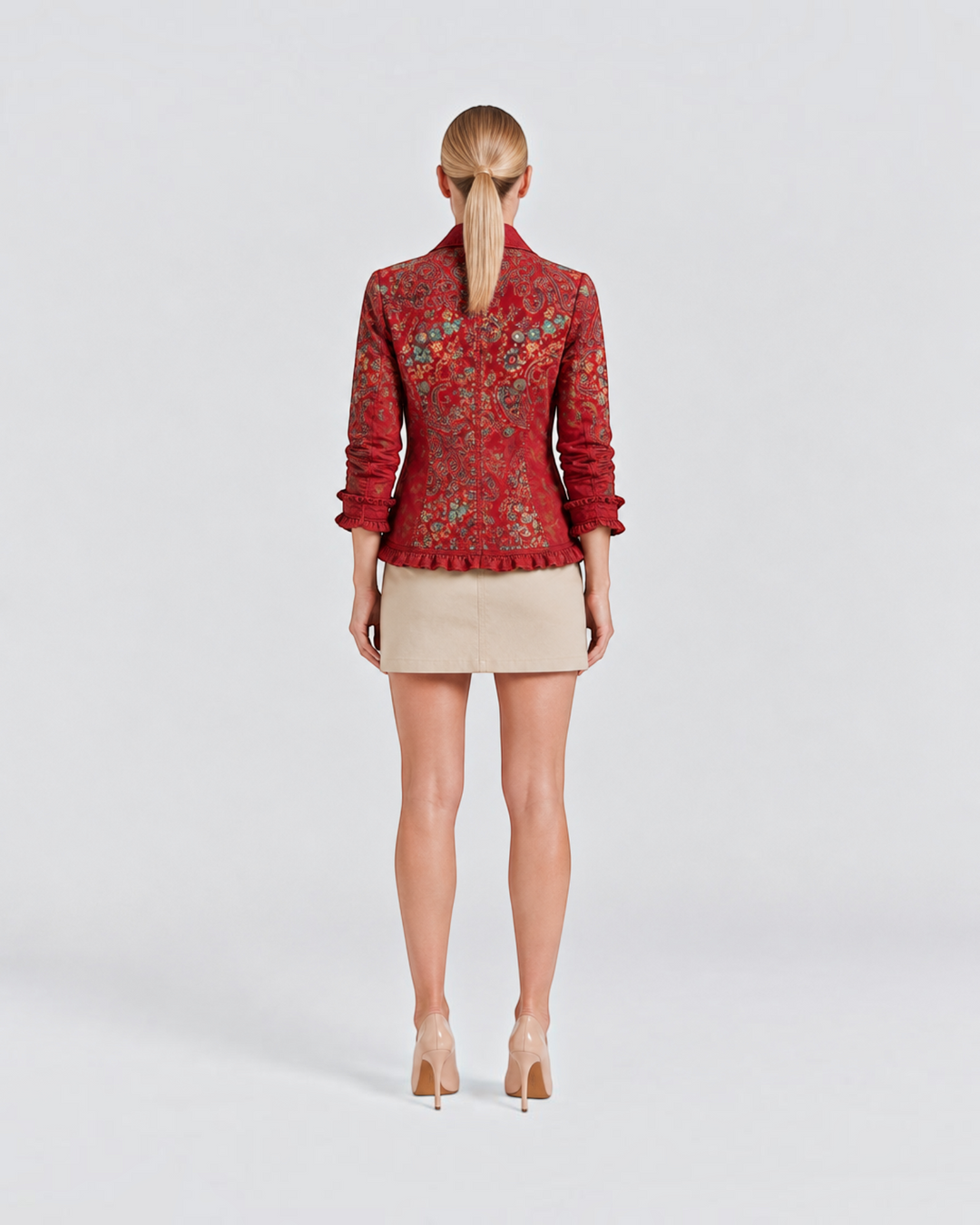 Luna Moda Agata jacket in red with paisley print, long sleeves, and ruffled lace trim worn over a beige skirt