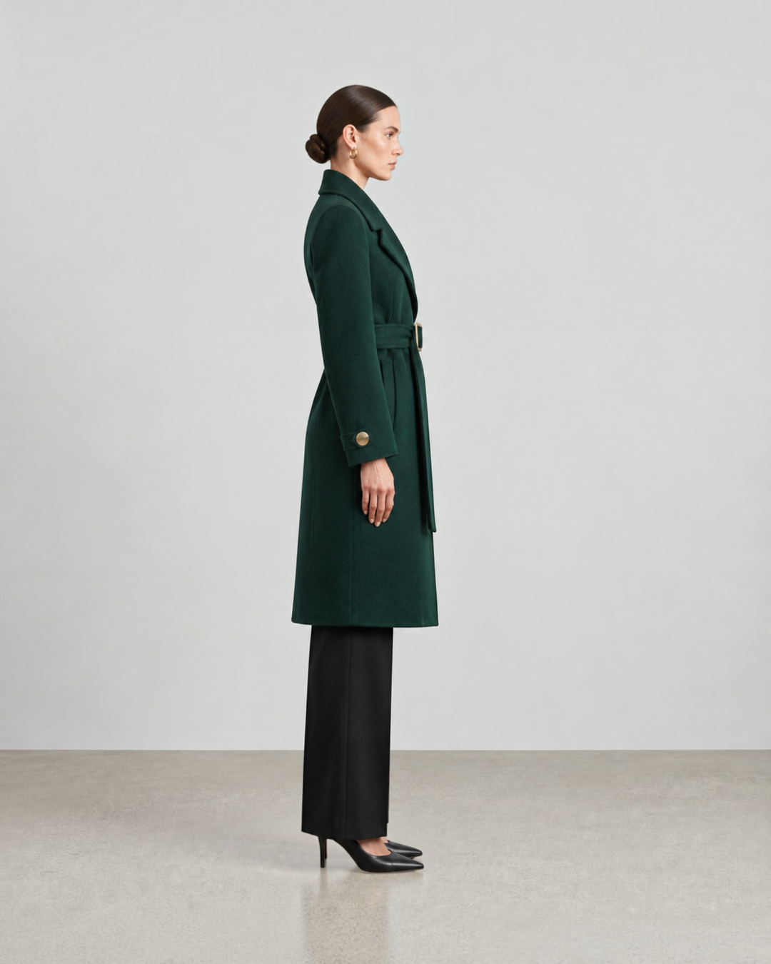 Luna Moda dark green wool-blend long coat with a belted waist, worn by a model in a side profile view.