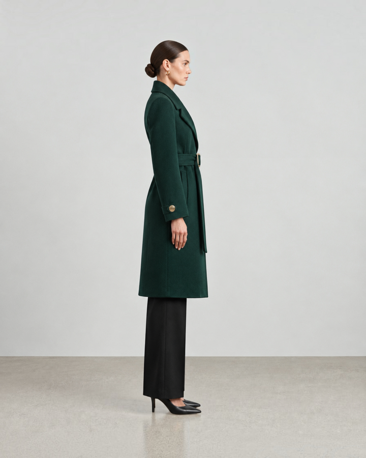 Luna Moda dark green wool-blend long coat with a belted waist, worn by a model in a side profile view.