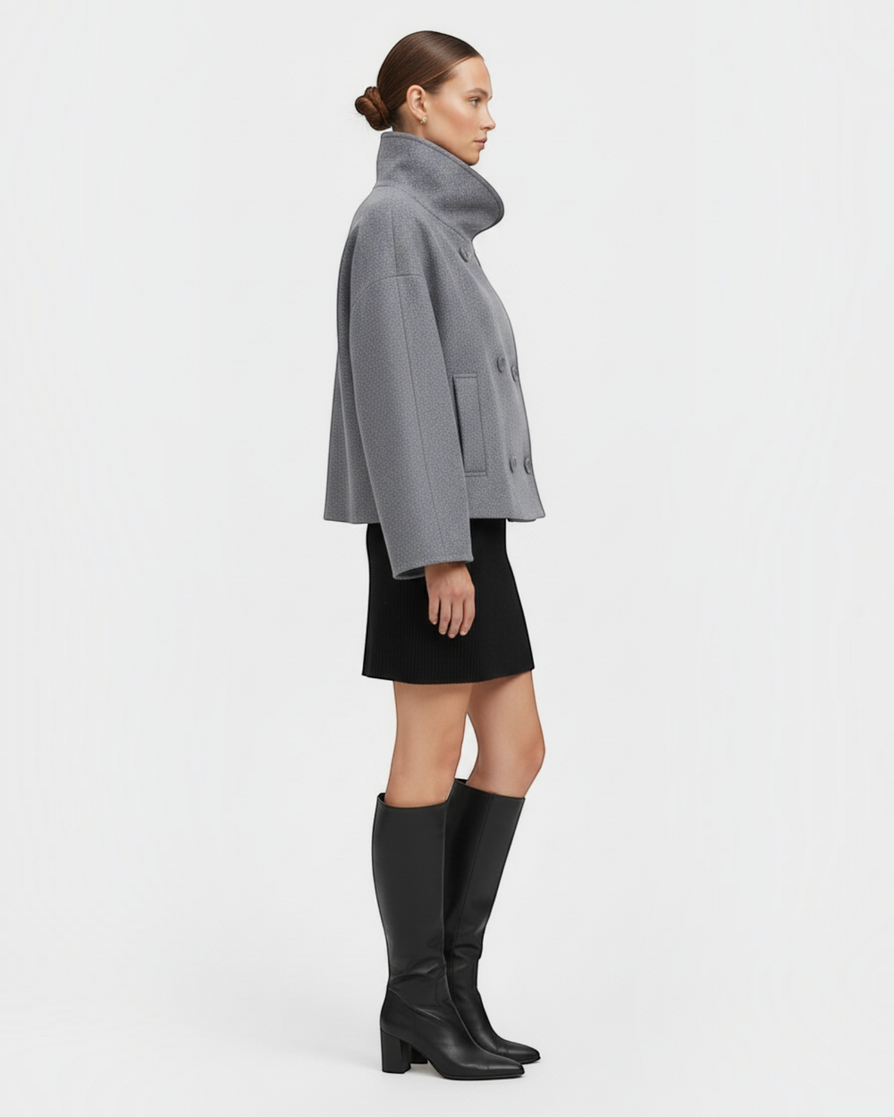 Luna Moda Francesca grey double-breasted mid-season coat worn by a model with a black skirt and knee-high boots