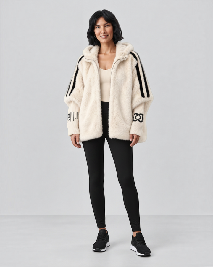 Luna Moda cream faux fur hooded jacket with black striped sleeves and decorative cuffs worn by a woman