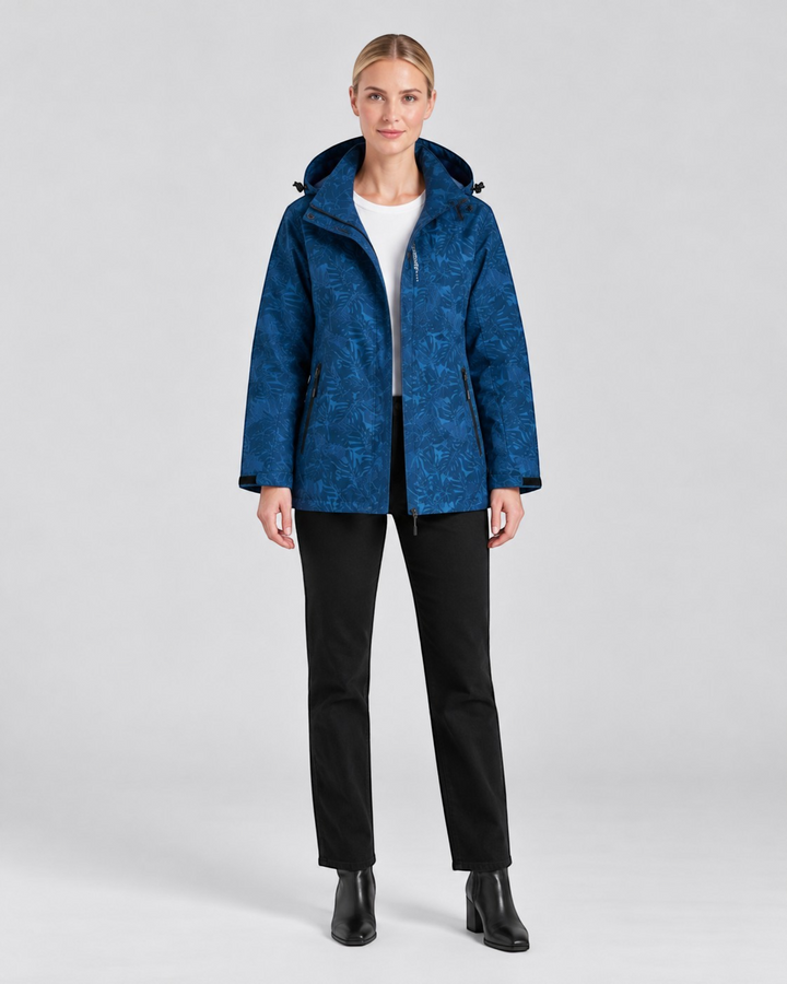 Luna Moda blue waterproof hooded jacket with a subtle leaf pattern worn by a model against a plain background.
