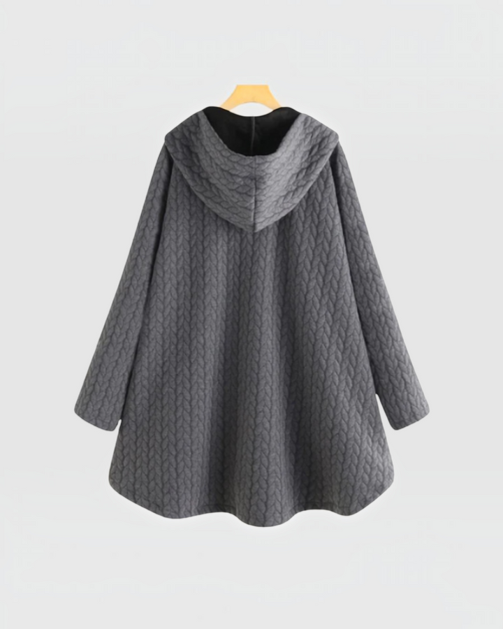 Luna Moda grey quilted hooded jacket with a loose fit and textured cable knit pattern on a hanger