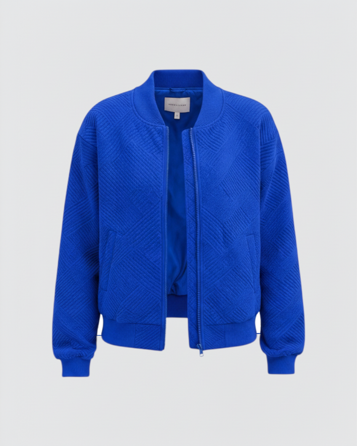 Luna Moda Dora bomber jacket in vibrant blue with a textured geometric pattern, front zip, and ribbed cuffs.