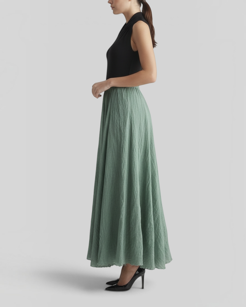 Luna Moda Matilde long sage green skirt with elastic waist and textured fabric worn by a model in profile view