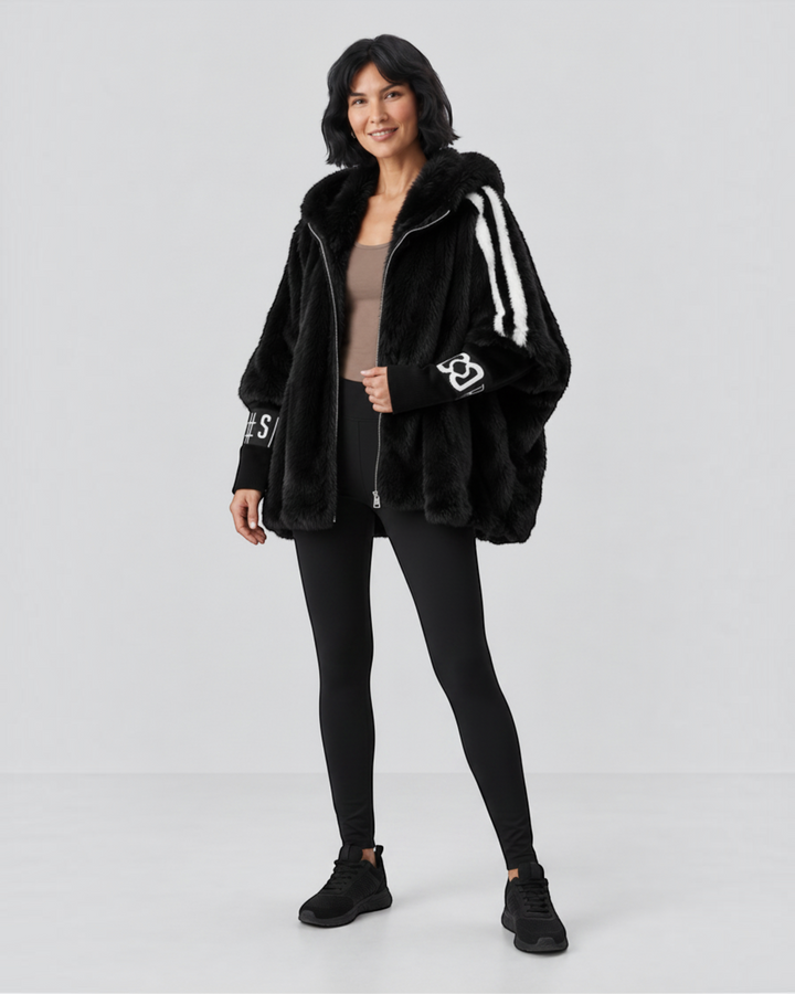 Luna Moda black faux fur hooded jacket with white striped sleeves and graphic detailing worn by a woman.