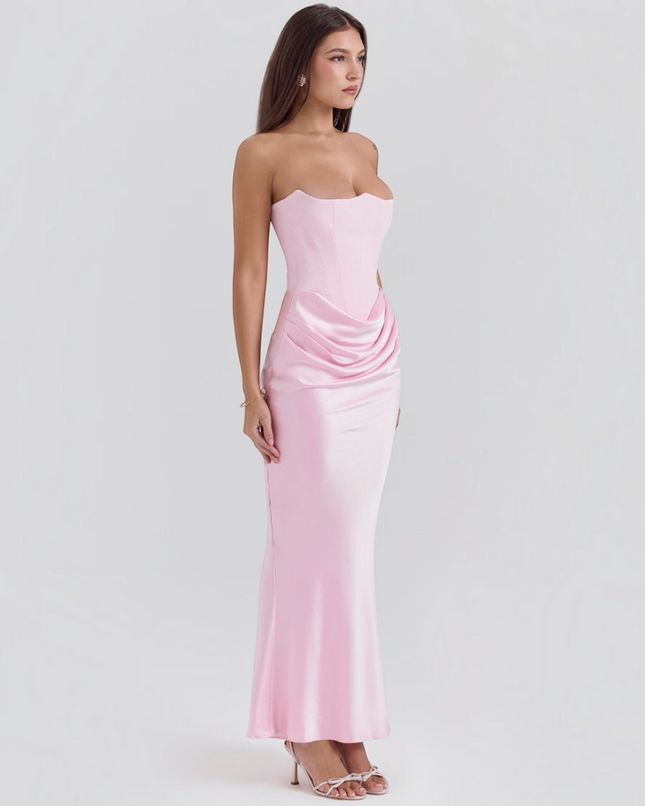 Luna Moda pink strapless evening gown with a structured corset bodice and elegant side-draped waist detail.