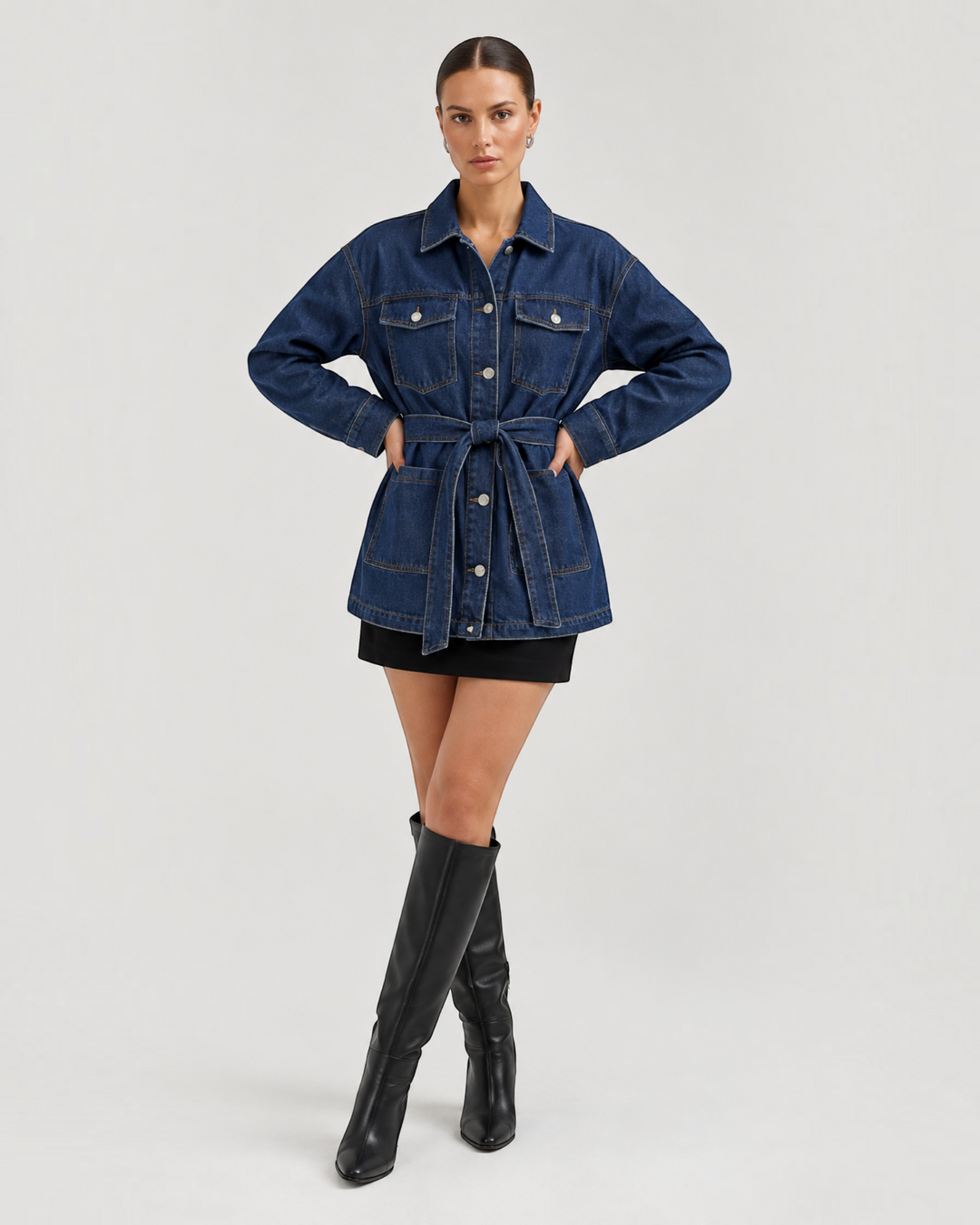 Luna Moda Alice relaxed fit dark blue denim jacket with a waist belt worn by a model with black skirt and boots