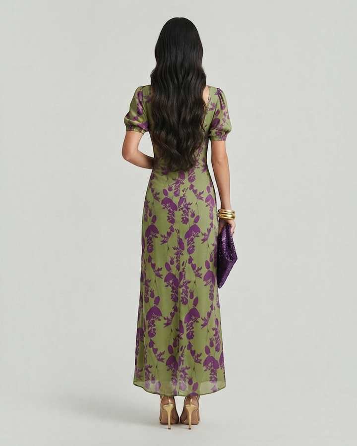 Luna Moda Andrea floral midi dress in olive green and purple with puff sleeves, worn by a woman from behind.