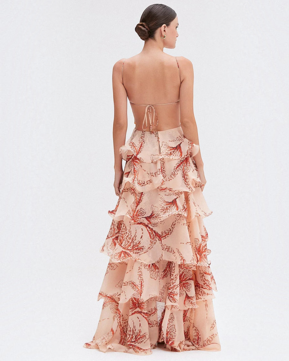 Luna Moda Nahia backless maxi dress in peach with red botanical print, featuring tiered ruffles and spaghetti straps