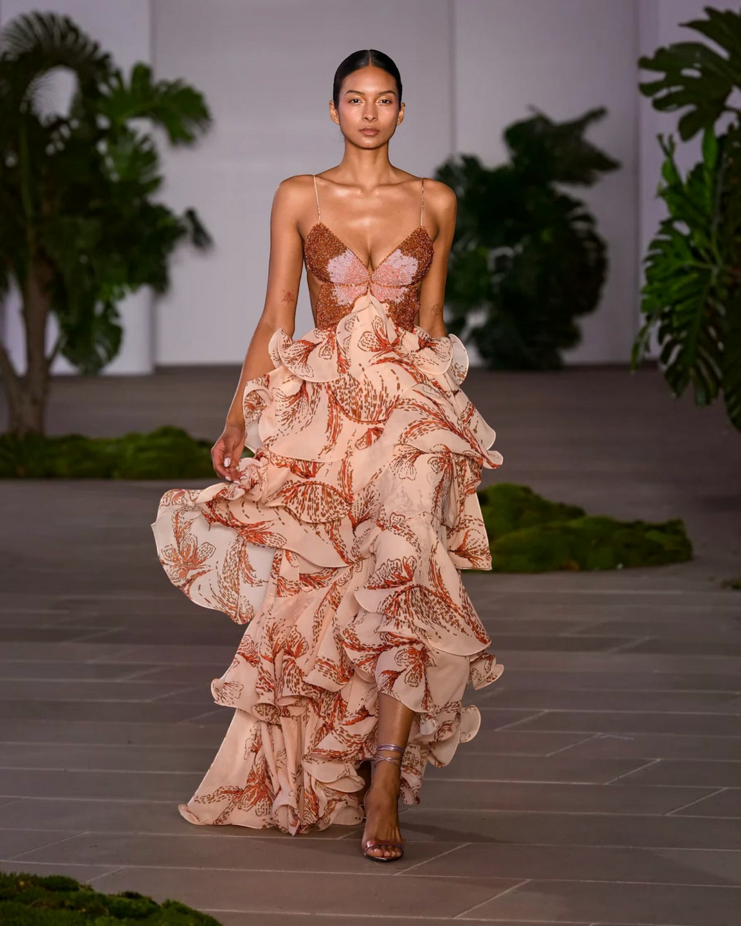 Model wearing a Luna Moda Nahia bohemian ruffled maxi dress with a jewel-embellished bodice on a runway.