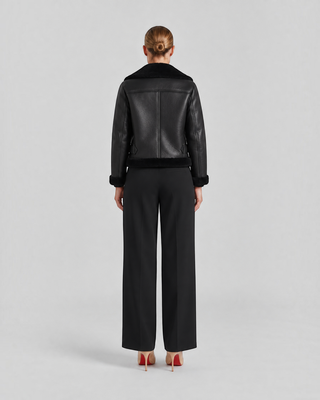 Luna Moda Claudia black fleece-lined jacket with zip details and waist belt, back view on a model