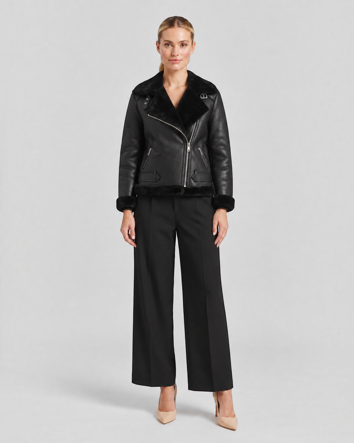 Luna Moda Claudia black fleece-lined jacket with zip details and waist belt worn by a model
