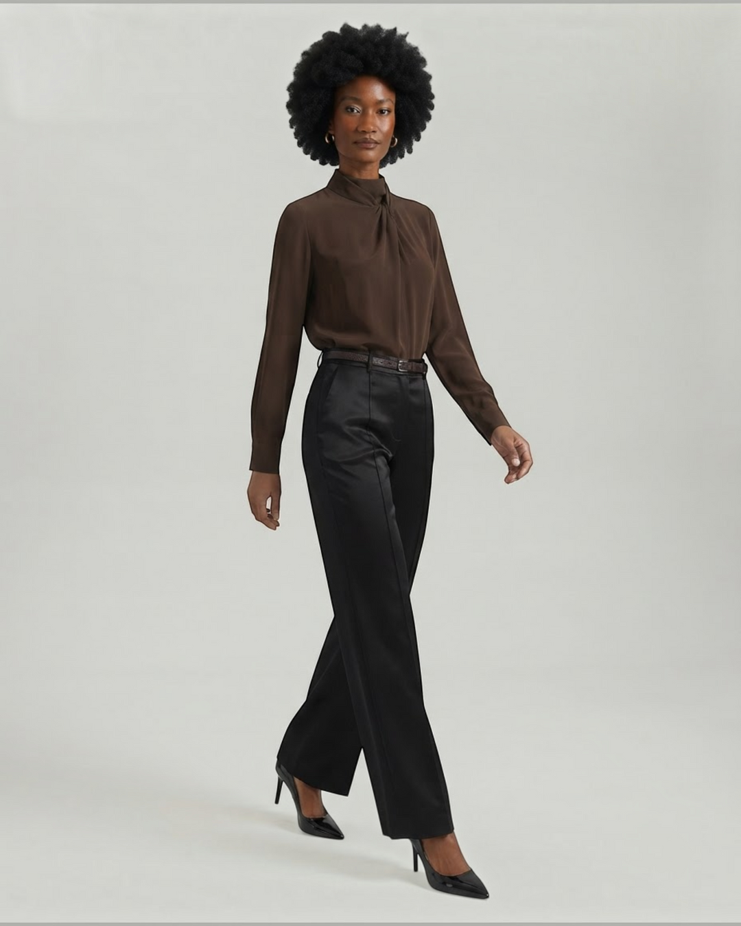 Luna Moda black palazzo trousers with front pleats and matching belt worn by a model with a brown blouse