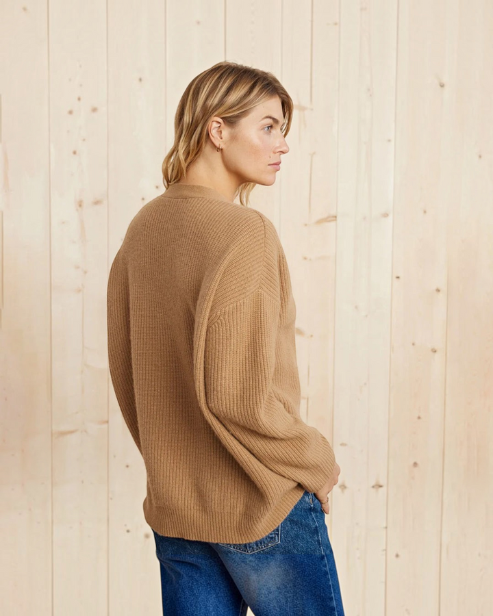 Luna Moda beige cashmere V-neck cardigan worn by a woman against a light wood background