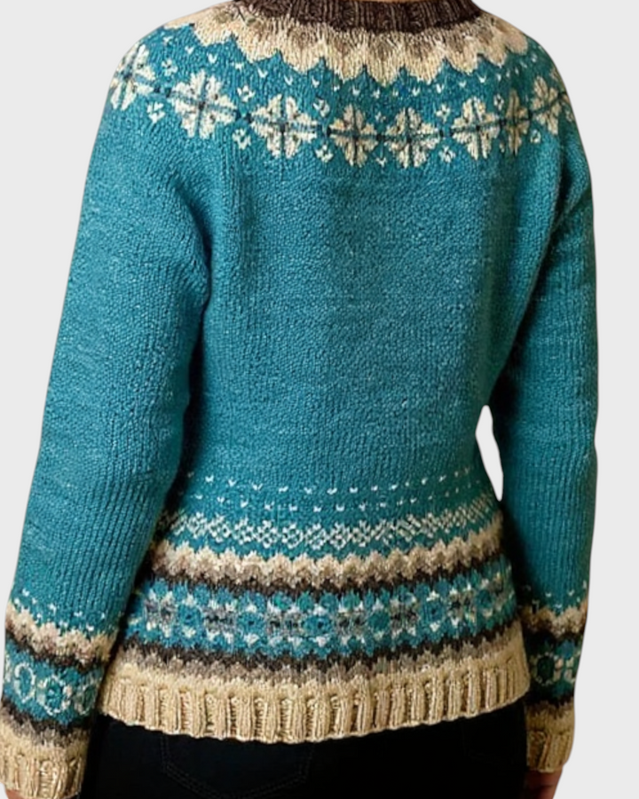 Luna Moda Giada cardigan featuring a teal blue base with intricate cream and brown Nordic patterns on the yoke and hem.