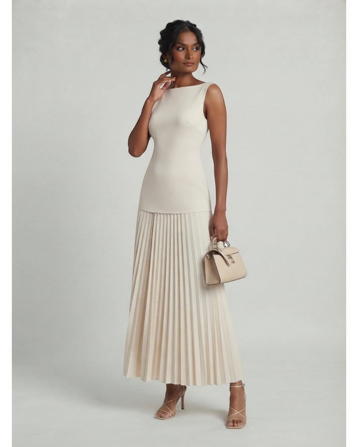 Luna Moda Celeste sleeveless maxi dress in cream with a structured bodice and elegant pleated skirt on a model.