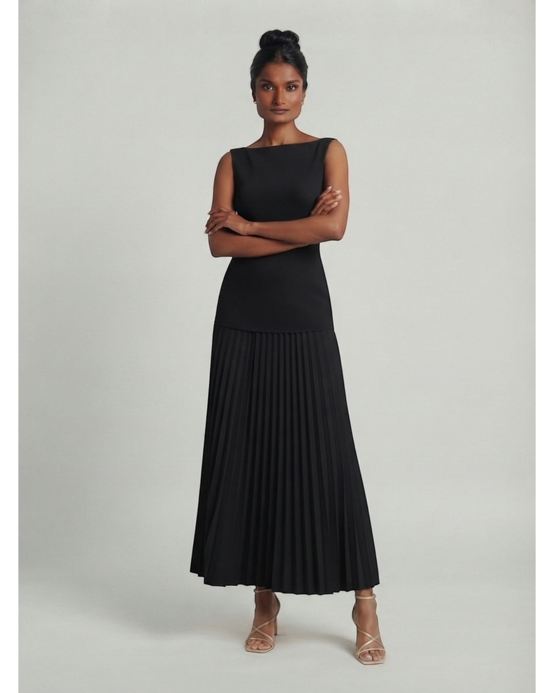 Luna Moda Celeste sleeveless black maxi dress with a structured bodice and pleated skirt worn by a model.